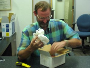 Phil pulling a rock out of a box